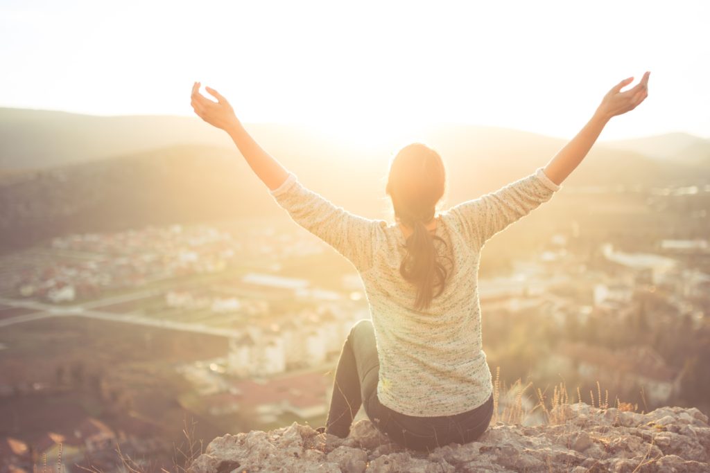 Girl Sitting raising Hands